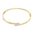 Pulsera rígida bañada en oro y trilogía de circonitas