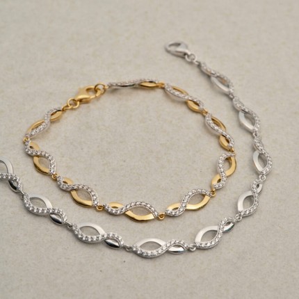 Pulseira banhada a ouro bicolor desenho 8 com zircónias